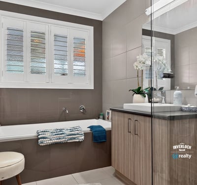 Modern bathroom featuring a spacious tub, ample natural light, and contemporary fixtures for everyday comfort.