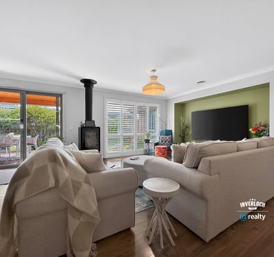 Bright living space featuring a cozy fireplace, modern decor, and seamless access to an outdoor area.