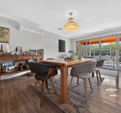 Bright and inviting dining area seamlessly connects to a lush outdoor space, perfect for entertaining.