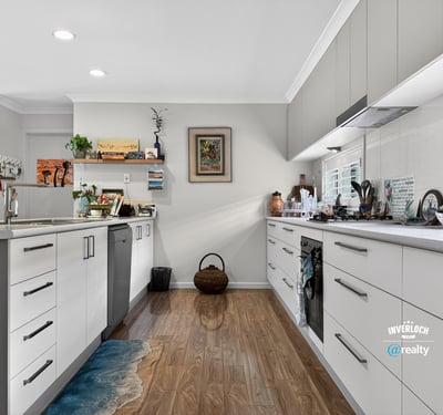 Modern kitchen featuring ample storage, sleek cabinetry, and a vibrant pop of color on the floor.