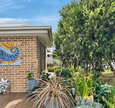 Vibrant garden space with artistic mural, perfect for enjoying outdoor relaxation and entertaining.