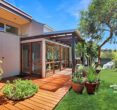 Showcasing a spacious deck surrounded by lush greenery, this property offers a perfect outdoor retreat.