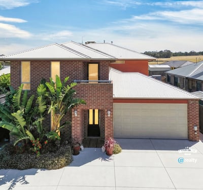 Modern home featuring a spacious layout, landscaped front yard, and ample natural light throughout.