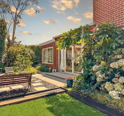 Discover this inviting outdoor space, featuring lush landscaping and a cozy seating area for relaxation.