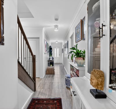 Discover a modern hallway featuring natural light, tasteful decor, and a welcoming ambiance throughout.