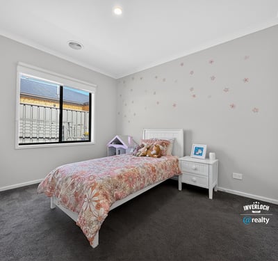 Bright and welcoming bedroom featuring modern decor and ample natural light, perfect for relaxation and rest.