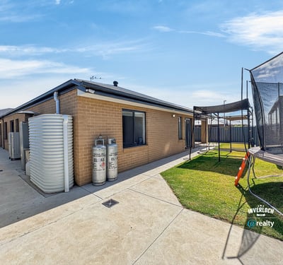 Modern home featuring spacious outdoor area with trampoline, perfect for family gatherings and playtime.
