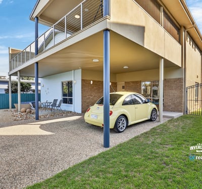 Spacious multi-level home featuring outdoor parking, a covered patio, and a lush backyard for relaxation.