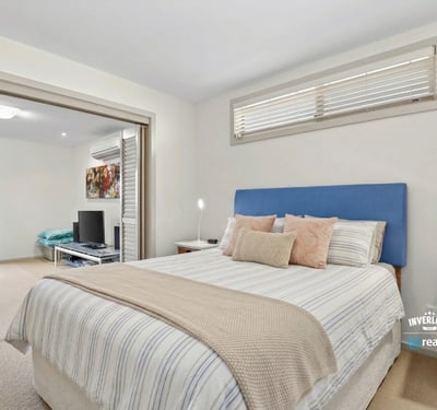 Bright and inviting bedroom with ample natural light, featuring a cozy atmosphere and modern finishes.