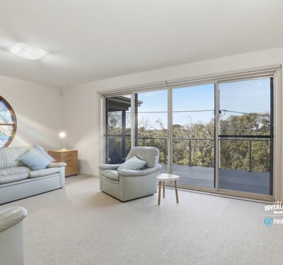 Spacious living area with panoramic views, ample natural light, and easy access to outdoor balcony space.
