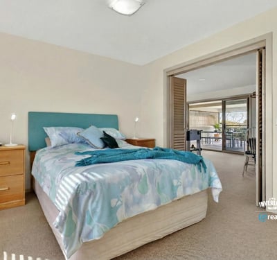 Bright and inviting bedroom with ample natural light and direct access to a spacious balcony.