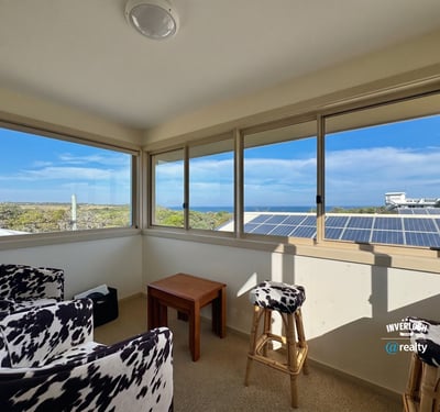 Bright sunroom with panoramic ocean views, perfect for relaxation and enjoying natural light.