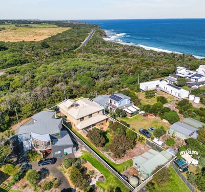 Coastal property featuring stunning ocean views, lush greenery, and easy access to scenic beachfront.