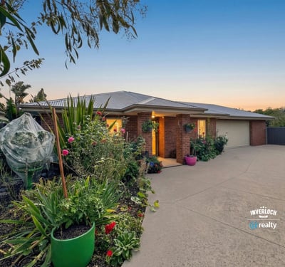Beautifully landscaped exterior with vibrant garden, inviting entrance, and ample parking space for multiple vehicles.