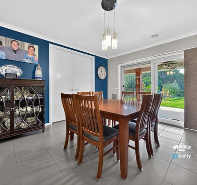 Spacious dining area with direct access to a well-maintained backyard, perfect for gatherings and entertaining.