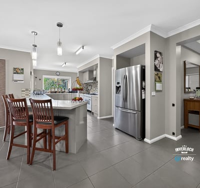 Modern kitchen with an open layout, featuring ample seating and contemporary appliances for everyday convenience.