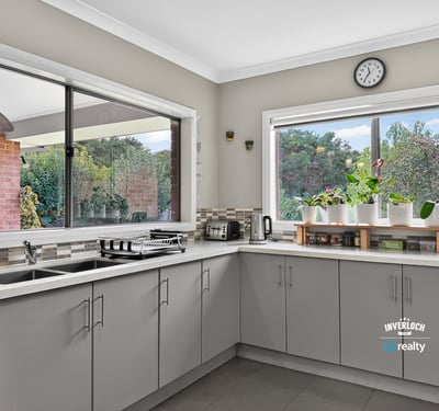 Modern kitchen featuring spacious countertops and abundant natural light, ideal for culinary enthusiasts and gatherings.