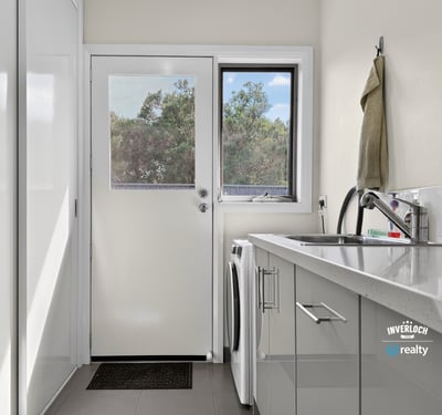 Bright and functional laundry area with modern appliances and natural light, perfect for everyday tasks.