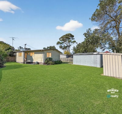 Expansive outdoor space surrounds a cozy cottage, providing ample room for relaxation and outdoor activities.