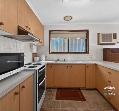 Spacious kitchen featuring ample cabinetry, a modern stove, and natural light throughout. Perfect for cooking enthusiasts.