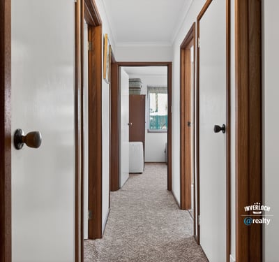 Discover a well-maintained hallway featuring ample natural light and easy access to various rooms.