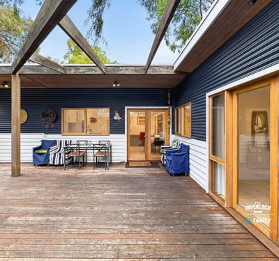 Spacious deck perfect for outdoor entertaining, seamlessly blends indoor and outdoor living in a picturesque setting.