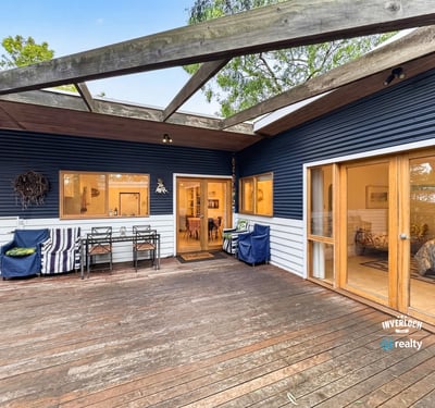 Spacious outdoor deck seamlessly connects to a cozy interior, perfect for entertaining and relaxation.