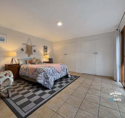 Spacious bedroom featuring ample storage, natural light, and direct access to the outdoor patio.
