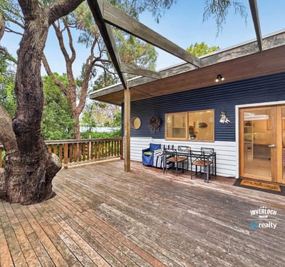 Spacious outdoor deck surrounded by nature, perfect for entertaining or relaxing in a tranquil setting.