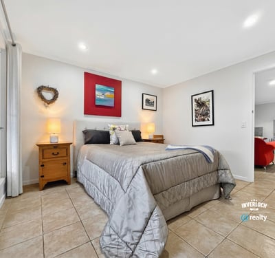 Spacious bedroom featuring modern decor, natural light, and ample storage for a comfortable living experience.