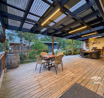 Discover this inviting outdoor space, perfect for entertaining and surrounded by lush greenery and tranquility.