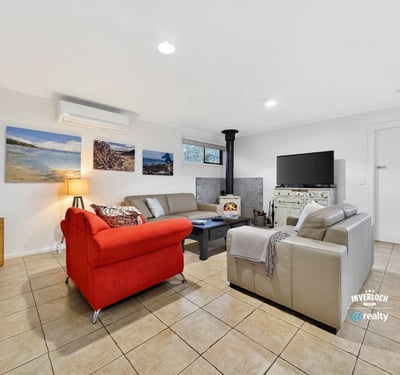 Bright and inviting living space featuring a cozy fireplace, modern furnishings, and ample natural light.