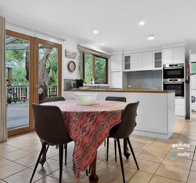 Spacious kitchen with modern appliances and direct access to an outdoor deck, perfect for entertaining.