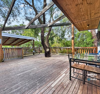 Spacious outdoor deck surrounded by nature, perfect for entertaining or relaxing in a private setting.