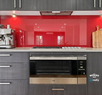 Modern kitchen featuring sleek cabinetry, a vibrant backsplash, and high-end appliances for culinary enthusiasts.