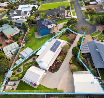 Spacious property featuring a large outdoor area and solar panels, nestled in a modern neighborhood.