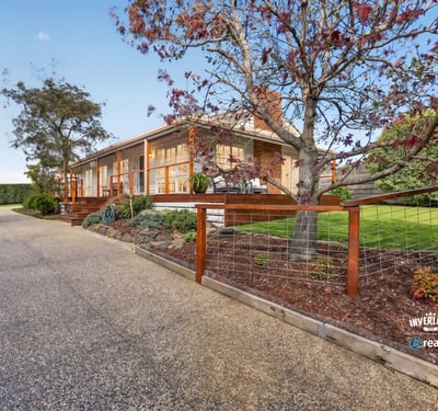 This welcoming home features spacious outdoor areas and a scenic driveway, perfect for family gatherings and relaxation.