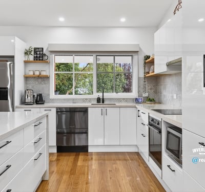 Modern kitchen featuring sleek cabinetry, stainless steel appliances, and abundant natural light for an inviting atmosphere.