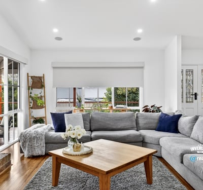 Spacious living area features large windows, offering abundant natural light and a cozy atmosphere.