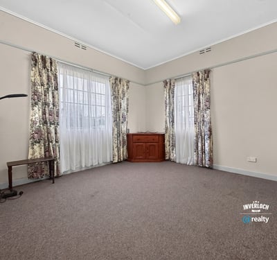 Spacious room featuring large windows, abundant natural light, and versatile flooring for various designs.