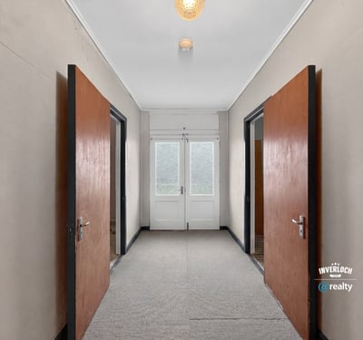 Spacious entrance featuring double doors, leading to sunlit rooms and versatile layout opportunities.