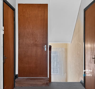 This inviting upper hallway features ample natural light and access to multiple rooms for convenience.