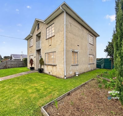 Spacious two-story home featuring a large yard and multiple windows for ample natural light.