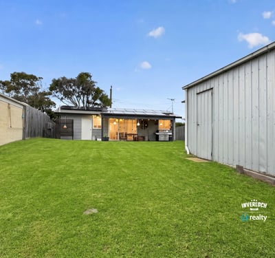 Spacious backyard perfect for outdoor activities, featuring a cozy home with modern amenities and ample storage.