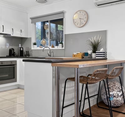 Modern kitchen featuring sleek cabinetry, a cozy breakfast bar, and ample natural light for culinary inspiration.
