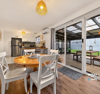 Bright, open-plan dining area seamlessly connects to an outdoor space, perfect for gatherings and relaxation.