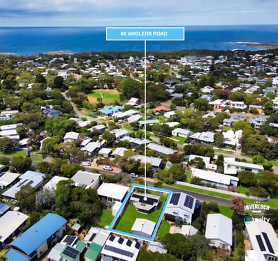 Discover a prime coastal property at 98 Anglers Road, surrounded by lush greenery and stunning ocean views.