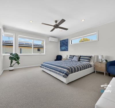 Bright and spacious bedroom featuring large windows, modern amenities, and a comfortable atmosphere for relaxation.