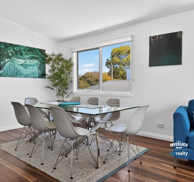 Bright dining area features modern furnishings, large windows, and a contemporary touch, perfect for gatherings.