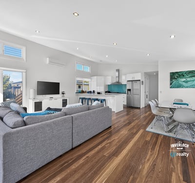 Modern open-plan living space with abundant natural light, featuring a spacious kitchen and inviting entertainment area.